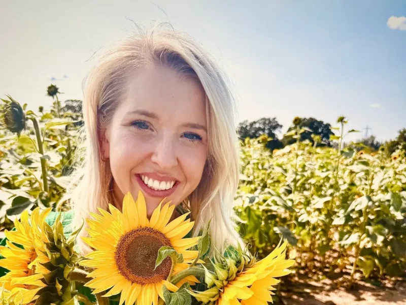 Eleanor Hayter holding sunflowers